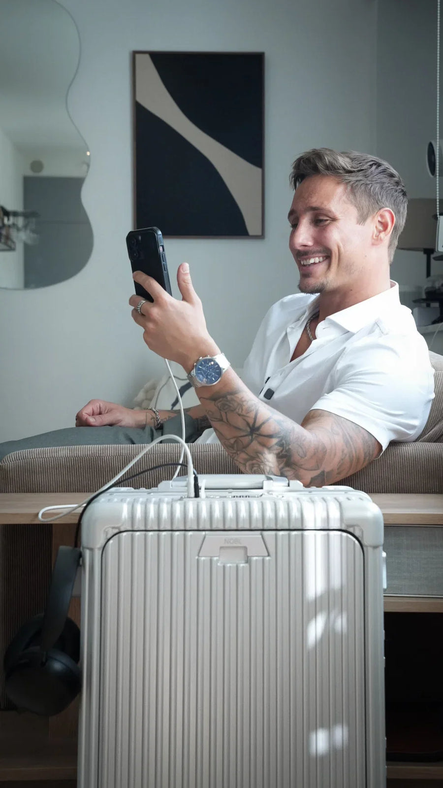 Smiling traveller with silver luggage