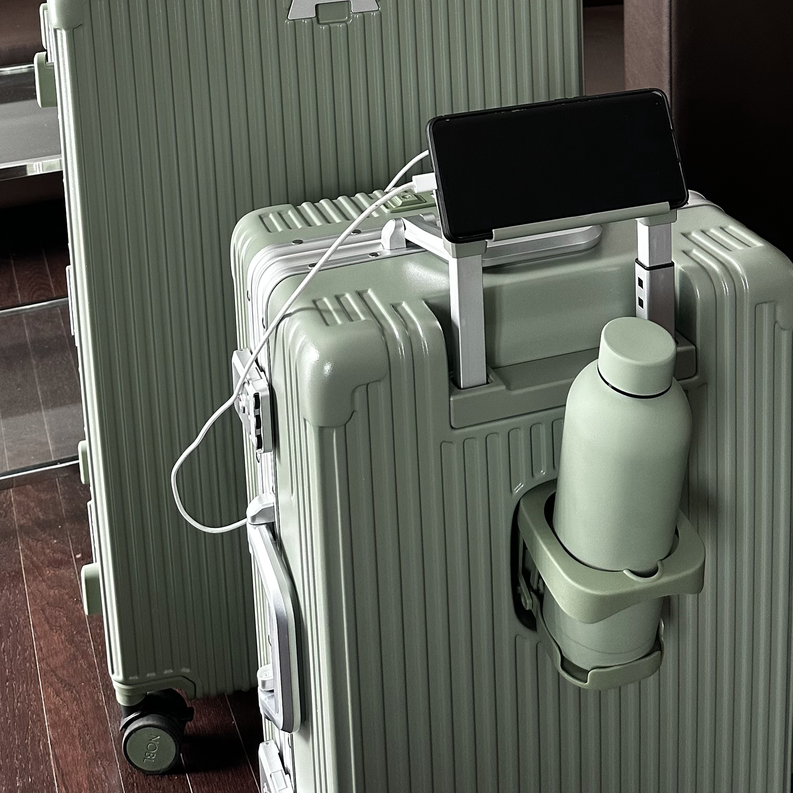 Mint NOBL carry-on with a coffee cup secured in the built-in cup holder